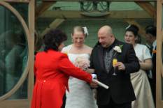 Toastmaster presenting marriage certificate to Bride and Groom after their wedding ceremony at Gaynes Park, Essex Near London